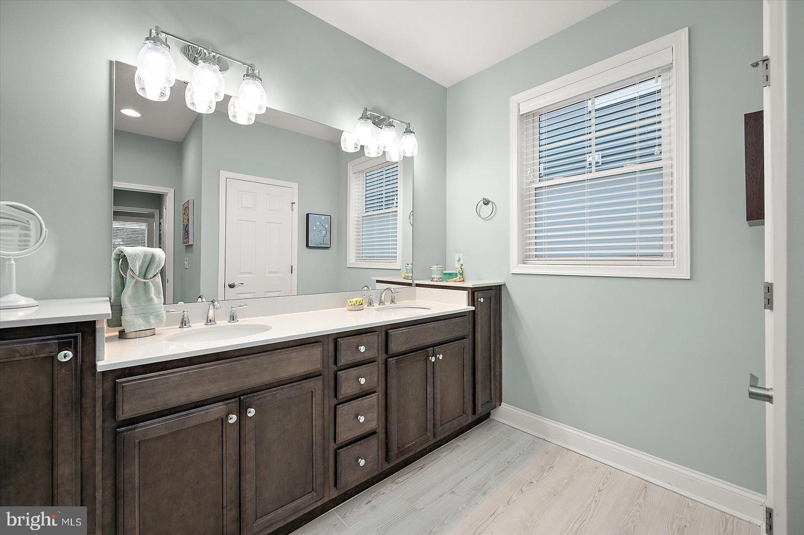 11271 Hall Road Lewes, DE 19958 - Photo 59 of 134 a spacious bathroom with a double vanity sink mirror and a bathtub