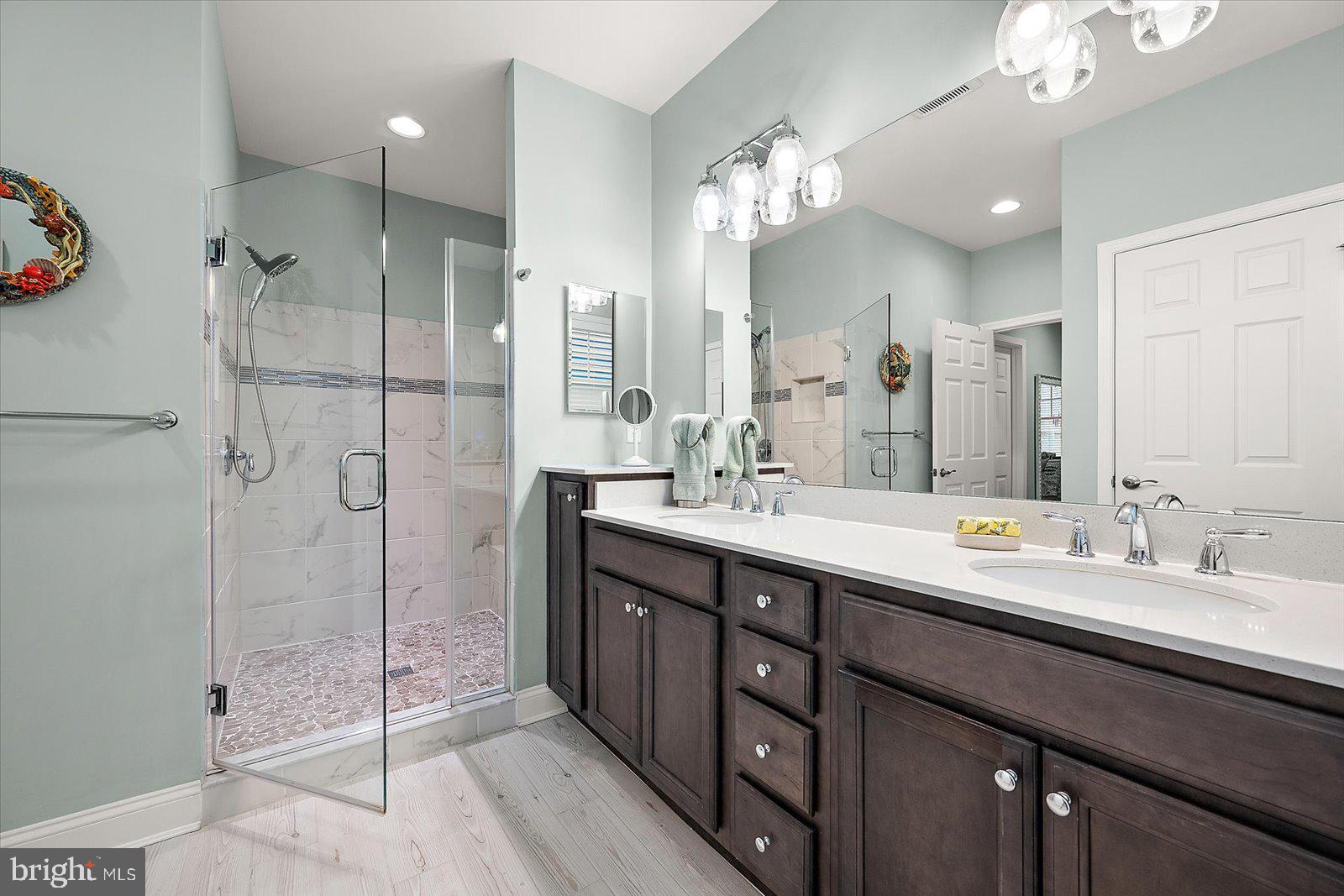 11271 Hall Road Lewes, DE 19958 - Photo 60 of 134 a bathroom with a double vanity sink mirror and shower