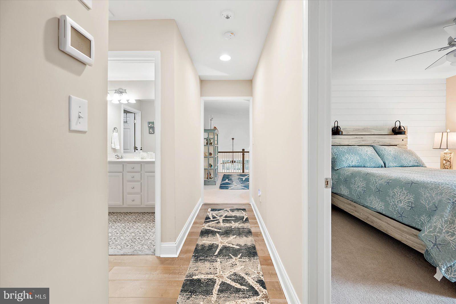 11271 Hall Road Lewes, DE 19958 - Photo 84 of 134 a bedroom with a bed and walk in closet with wooden floor