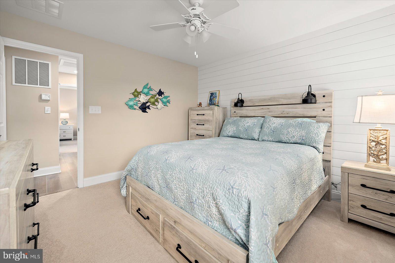 11271 Hall Road Lewes, DE 19958 - Photo 87 of 134 a bedroom with a bed and a chandelier