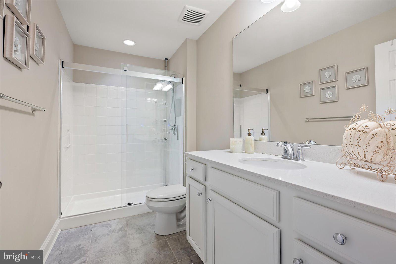 11271 Hall Road Lewes, DE 19958 - Photo 91 of 134 a spacious bathroom with a granite countertop sink toilet and shower