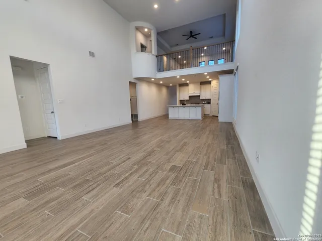 a view of a kitchen with furniture and wooden floor