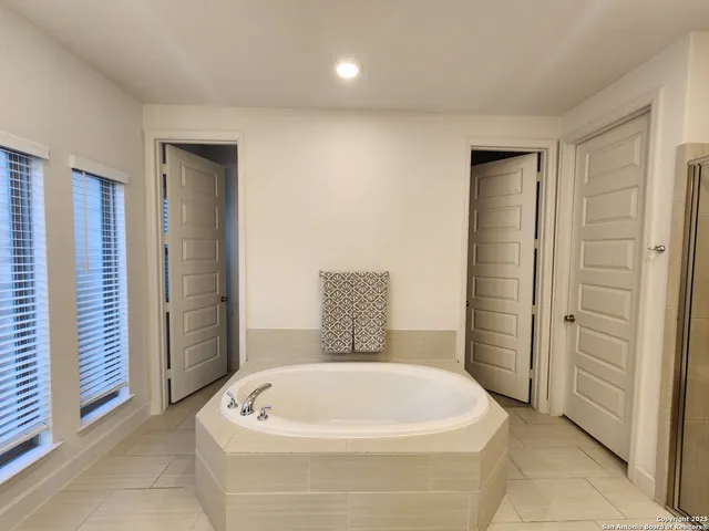 a white bath tub sitting in a bathroom