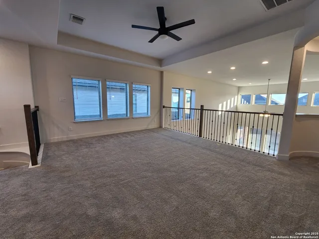 a view of a livingroom with a ceiling fan and window