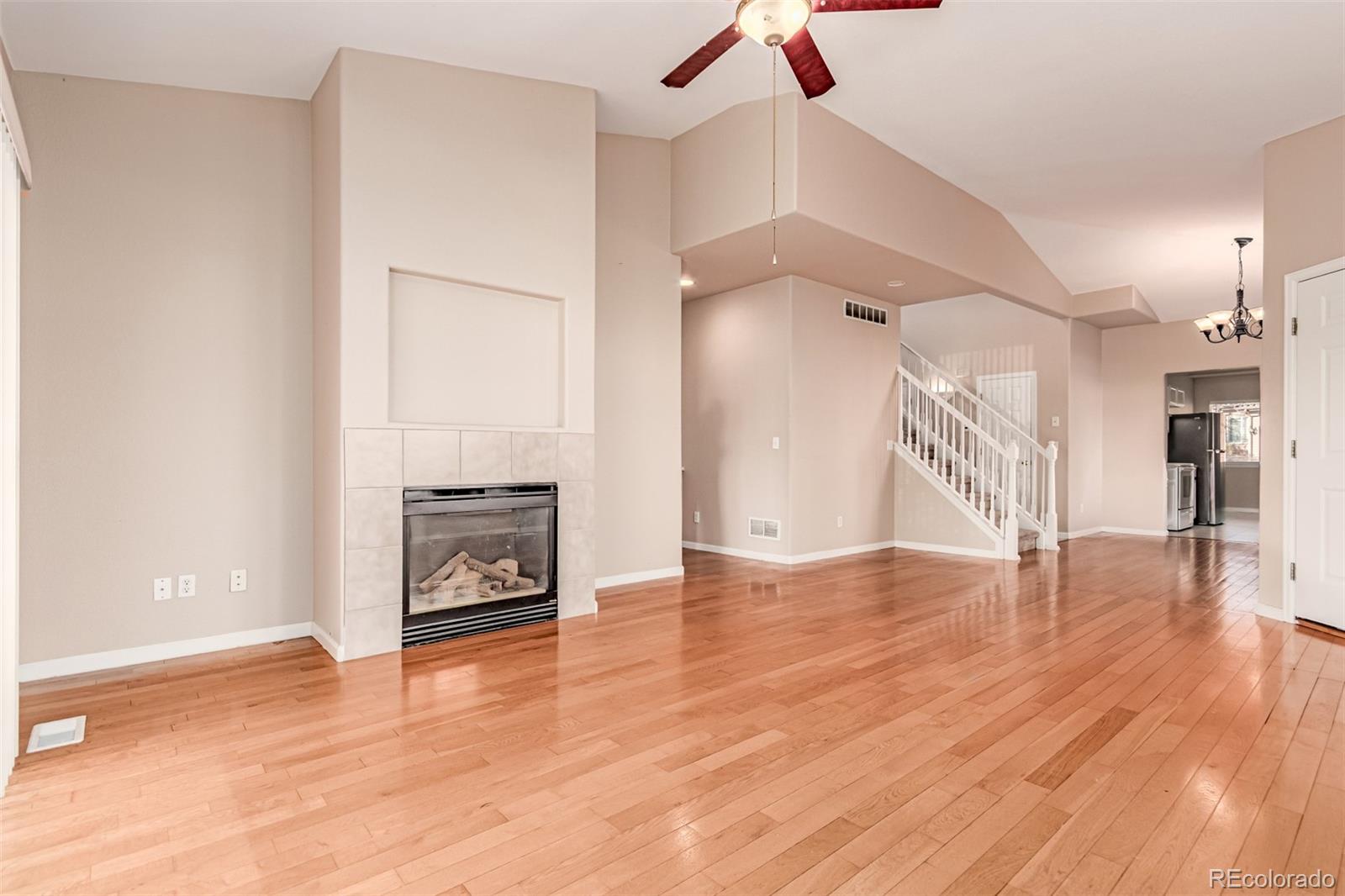 4538 South Atchison Way Aurora, CO 80015 - Photo 12 of 50 a view of an empty room with wooden floor fire place