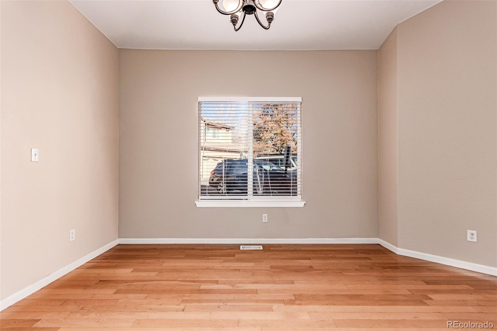 4538 South Atchison Way Aurora, CO 80015 - Photo 14 of 50 a view of an empty room with wooden floor and a window