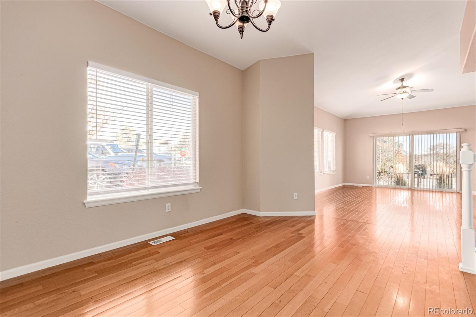 4538 South Atchison Way Aurora, CO 80015 - Photo 17 of 50 a view of an empty room with wooden floor and a window