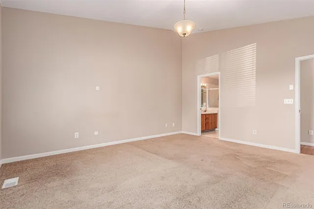 an empty room with an empty space and a ceiling fan