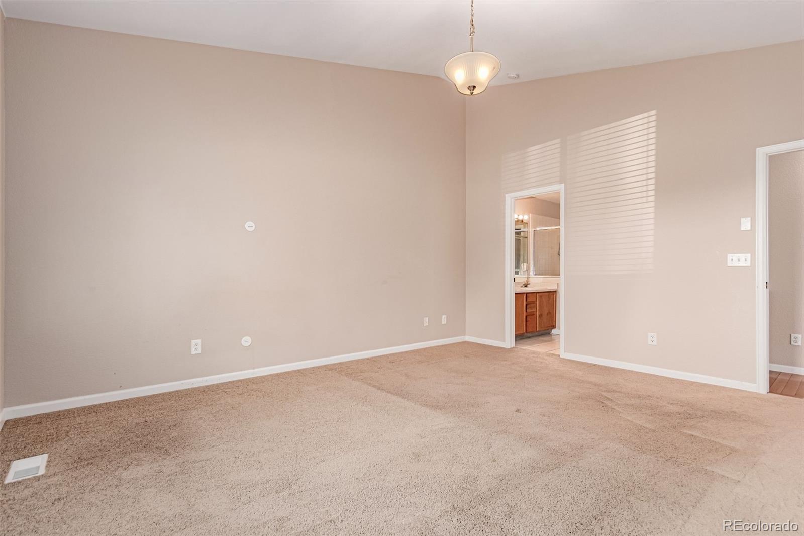 4538 South Atchison Way Aurora, CO 80015 - Photo 24 of 50 an empty room with an empty space and a ceiling fan
