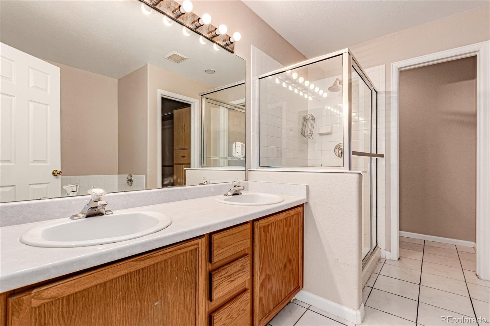 4538 South Atchison Way Aurora, CO 80015 - Photo 30 of 50 a bathroom with a sink and a mirror