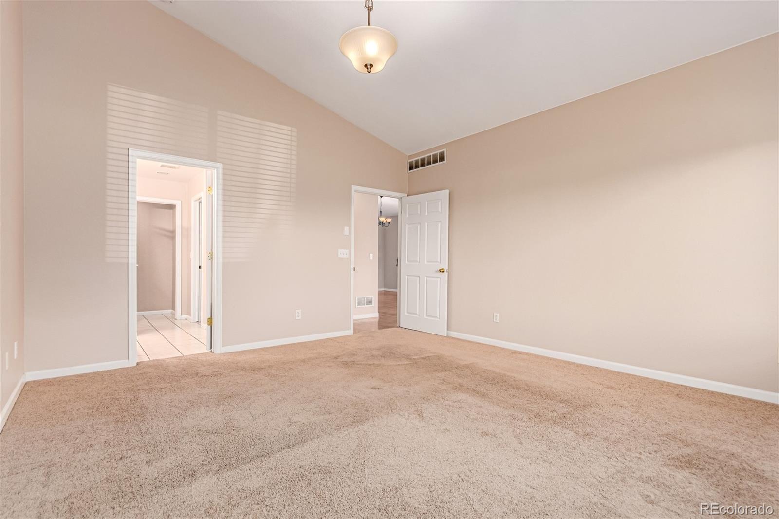 4538 South Atchison Way Aurora, CO 80015 - Photo 34 of 50 a view of an empty room with a chandelier fan
