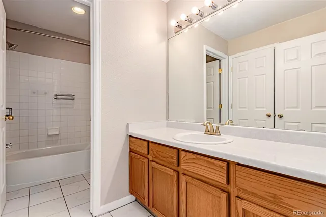 a bathroom with a double vanity sink a mirror and a bathtub