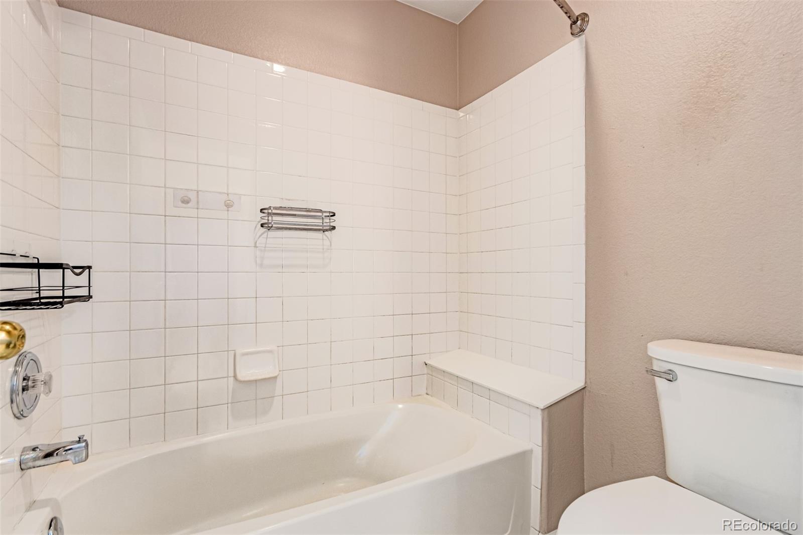 4538 South Atchison Way Aurora, CO 80015 - Photo 40 of 50 a bathroom with a bathtub and a toilet