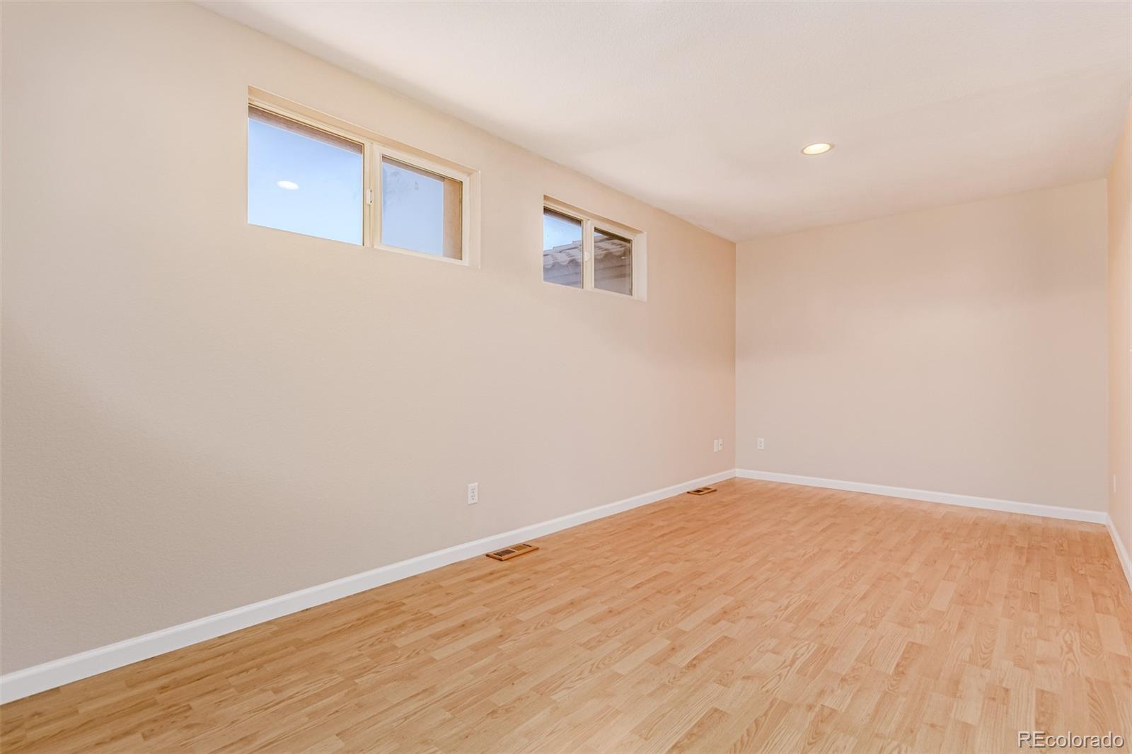 4538 South Atchison Way Aurora, CO 80015 - Photo 41 of 50 a view of an empty room with wooden floor and a window