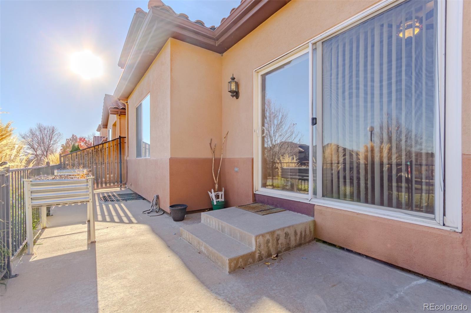 4538 South Atchison Way Aurora, CO 80015 - Photo 49 of 50 a spacious bedroom with a large bed and a chandelier