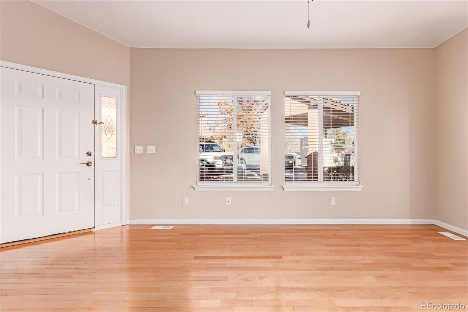 4538 South Atchison Way Aurora, CO 80015 - Photo 7 of 50 a view of an empty room with wooden floor and a window