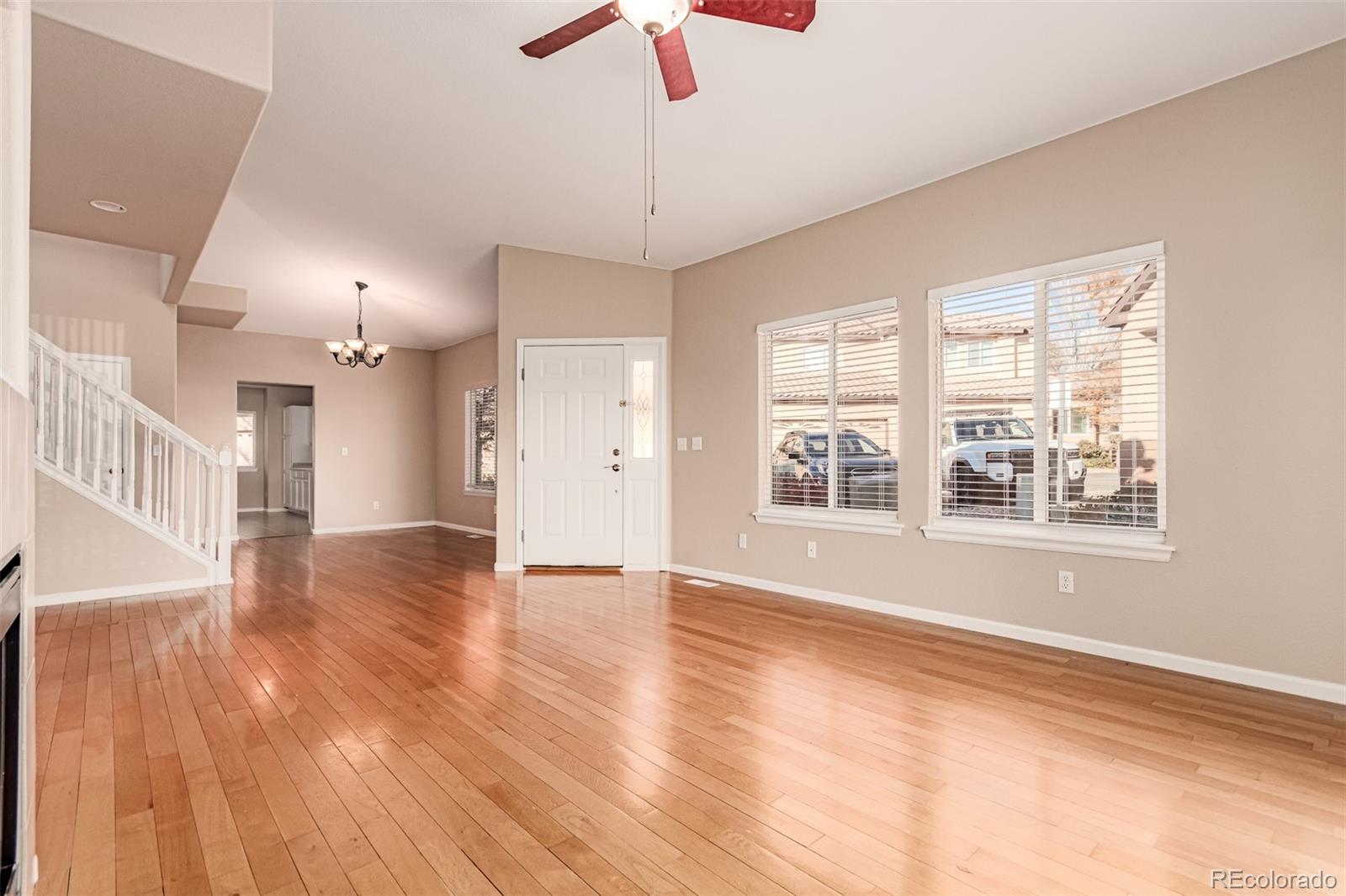 4538 South Atchison Way Aurora, CO 80015 - Photo 9 of 50 a view of an empty room with a window and wooden floor