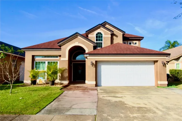 a front view of a house with a yard and garage