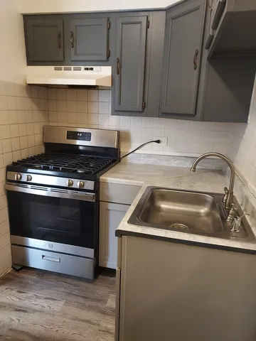 a close view of a stove top oven and a sink