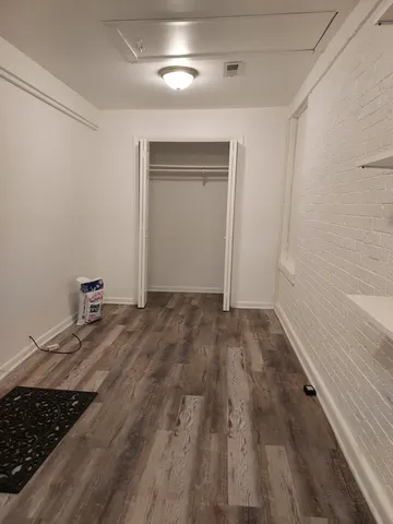 a view of a livingroom with wooden floor and staircase