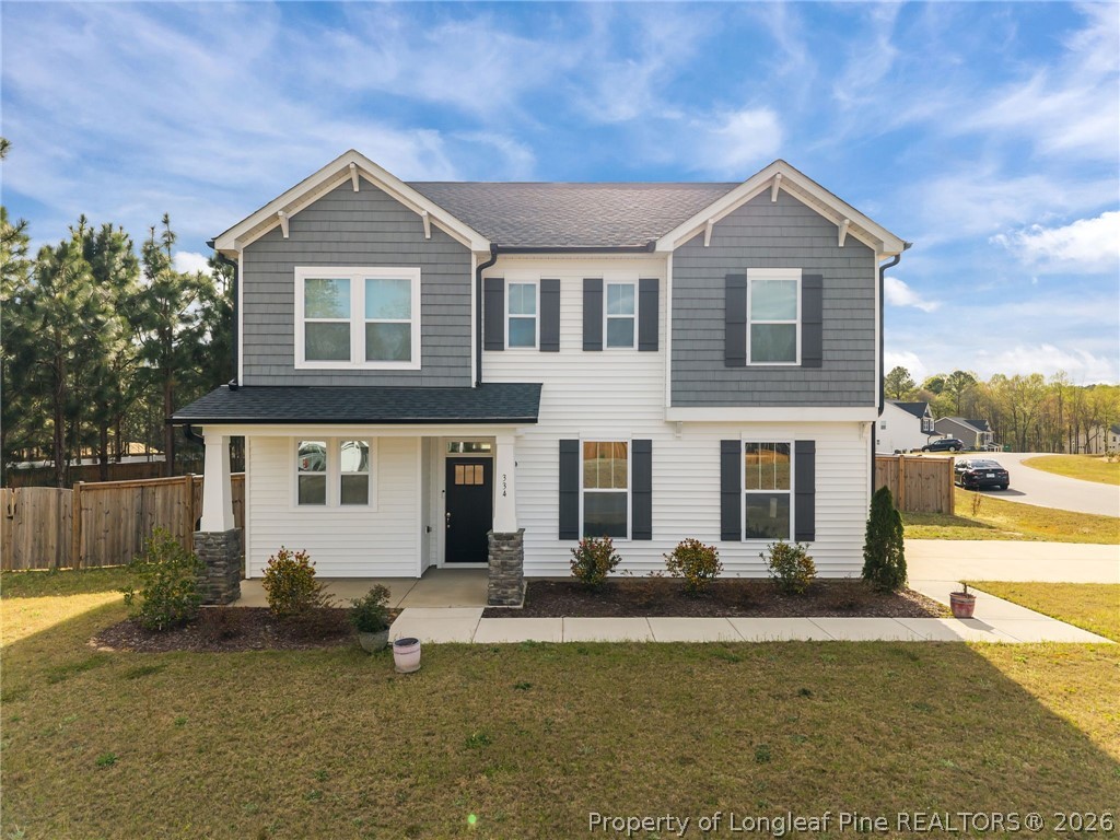 334 Beacon Hl Road Lillington, NC 27546 - Photo 1 of 49 a front view of a house with swimming pool and glass top table and chairs