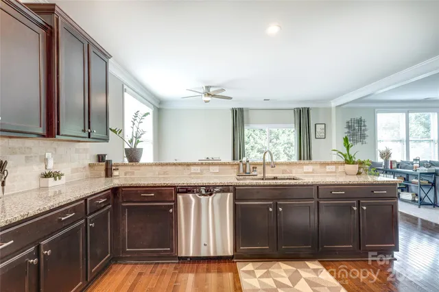 a kitchen with granite countertop a sink and cabinets