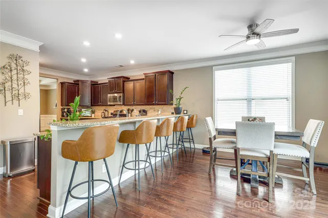 a view of kitchen with granite countertop cabinets table and chairs