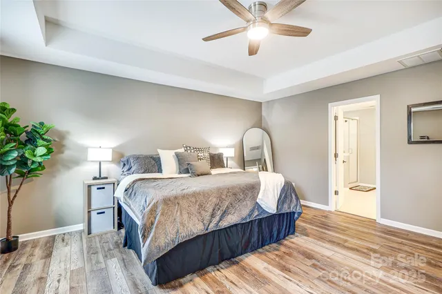 a bedroom with bed and a potted plant
