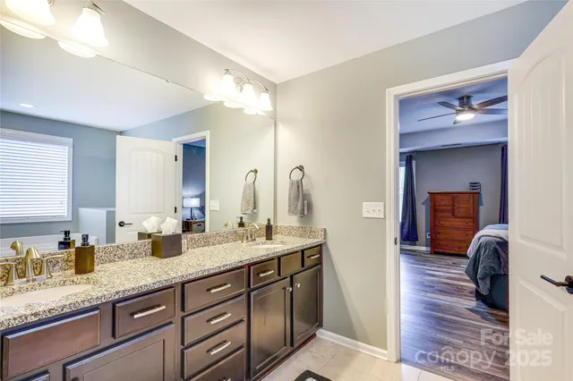 a spacious bathroom with a granite countertop sink and a mirror