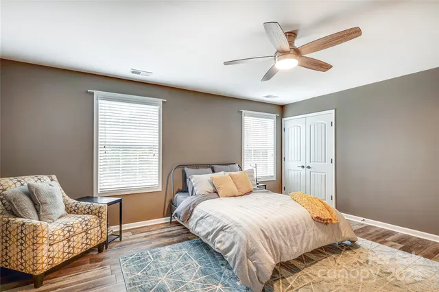 a bedroom with a bed couch and window