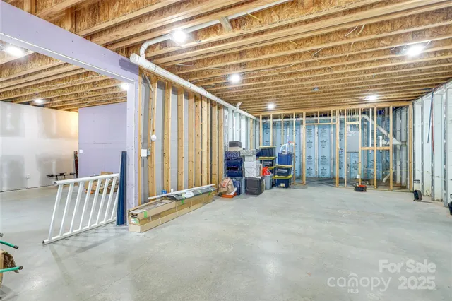 a view of a room with wooden furniture and large windows