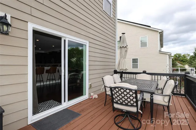 a view of a chairs and table in the balcony