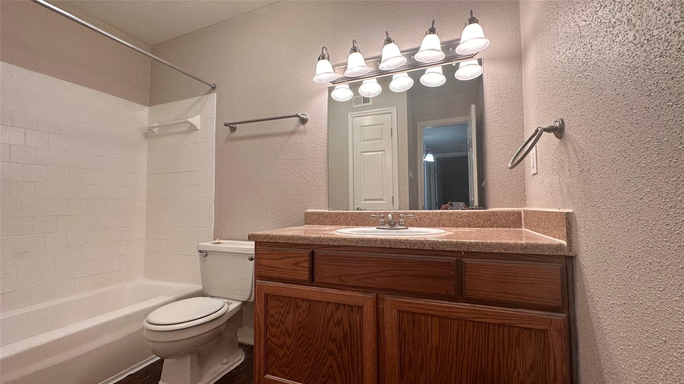 7315 Brompton Street, Unit 303B Houston, TX 77025 - Photo 14 of 14 a bathroom with a sink a toilet and a mirror
