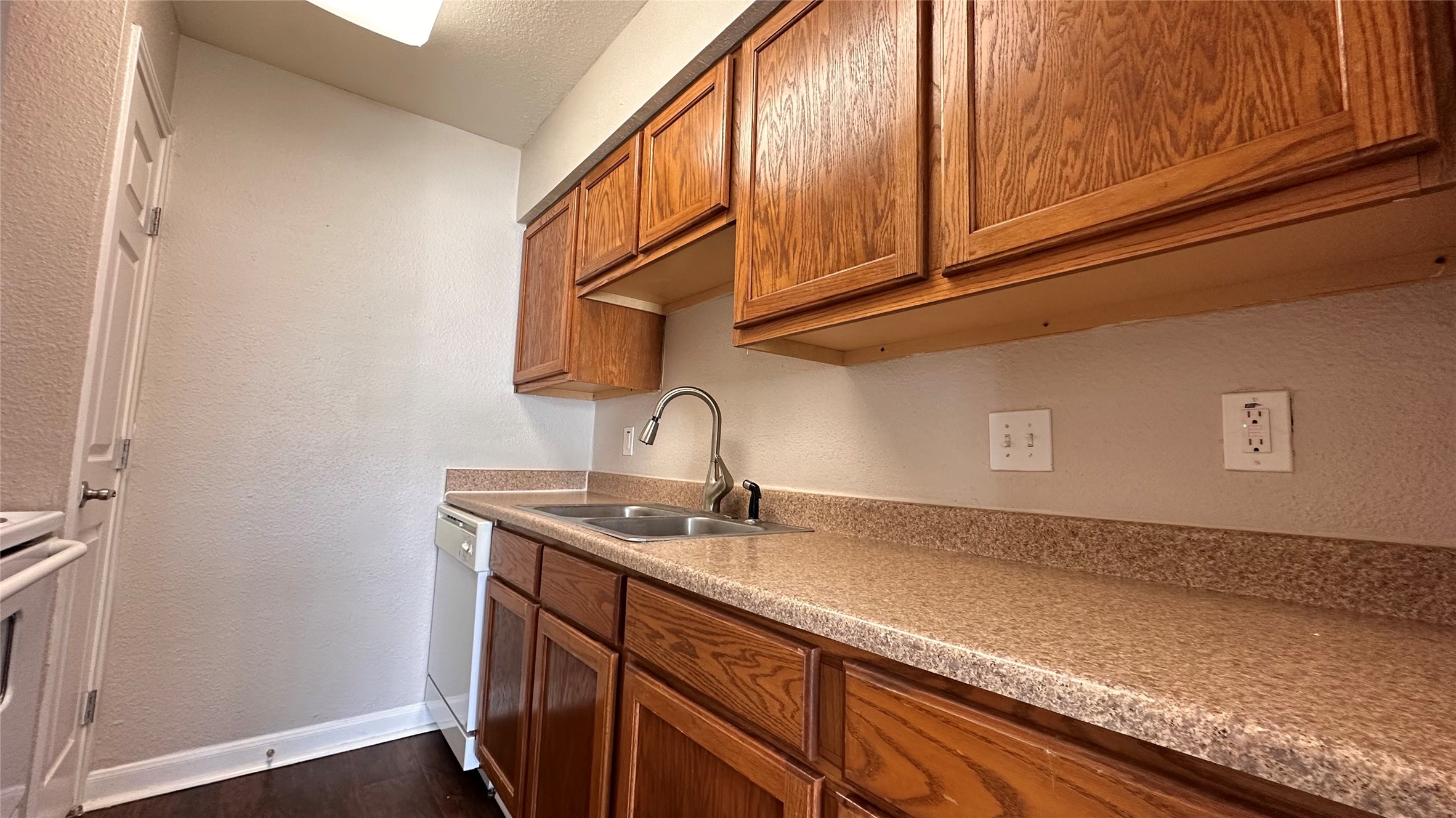 7315 Brompton Street, Unit 303B Houston, TX 77025 - Photo 4 of 14 a kitchen with a sink and cabinets