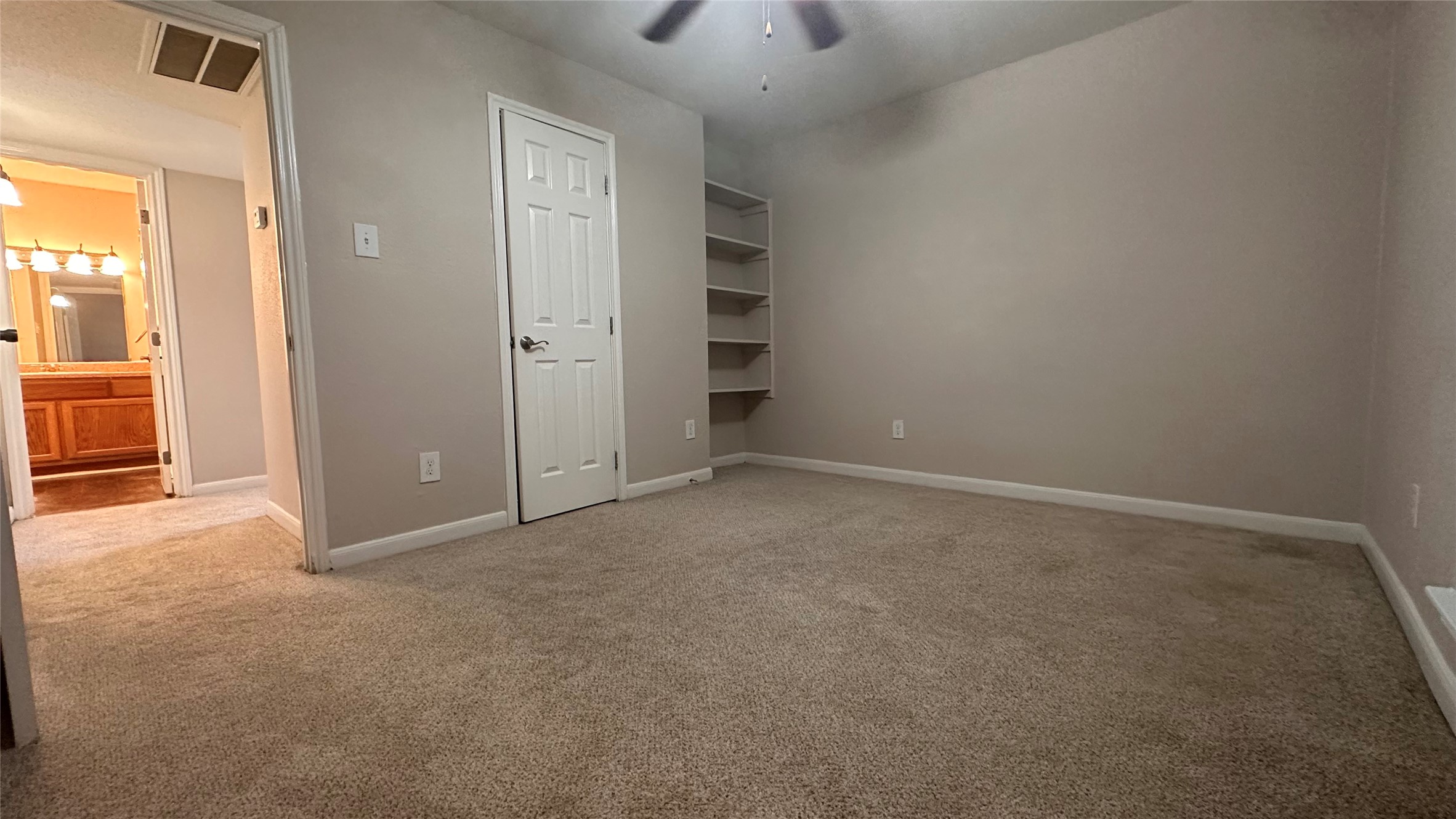 7315 Brompton Street, Unit 303B Houston, TX 77025 - Photo 8 of 14 an empty room with closet and windows