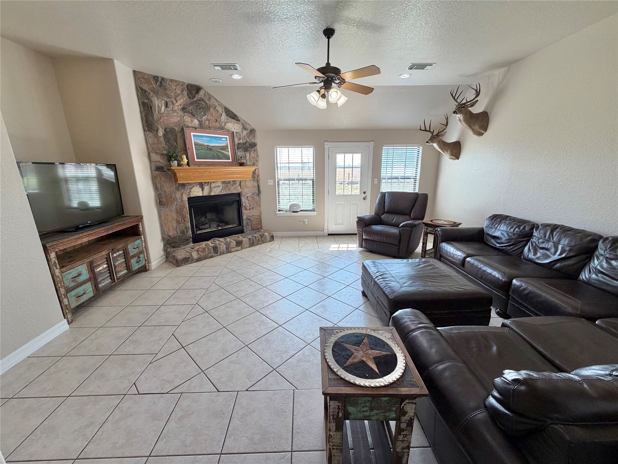 15903 County Road 621 Angleton, TX 77515 - Photo 9 of 33 a living room with furniture a fireplace and flat screen tv