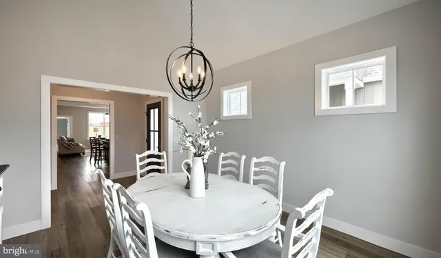 a view of a dining room with furniture wooden floor and chandelier