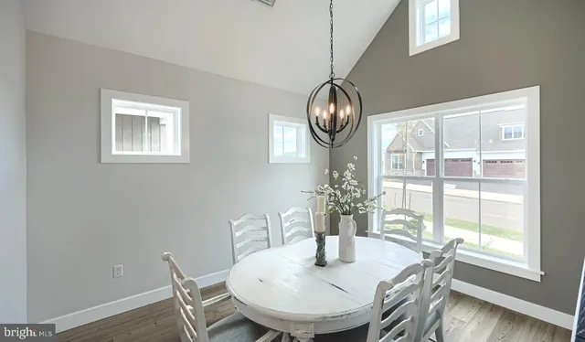 a view of a dining room with furniture wooden floor and chandelier