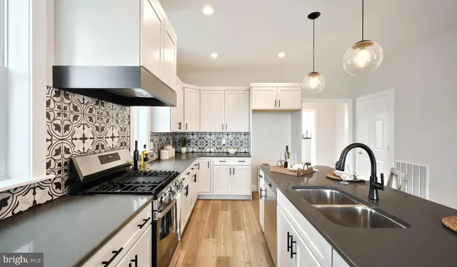 a kitchen with a sink stove and cabinets