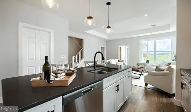 a kitchen with counter top space and living room