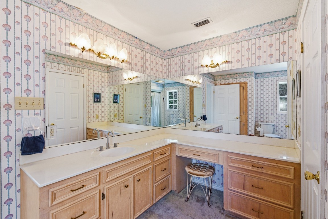 11847 Friar Road Cuero, TX 77954 - Photo 22 of 50 a spacious bathroom with a double vanity sink and a mirror