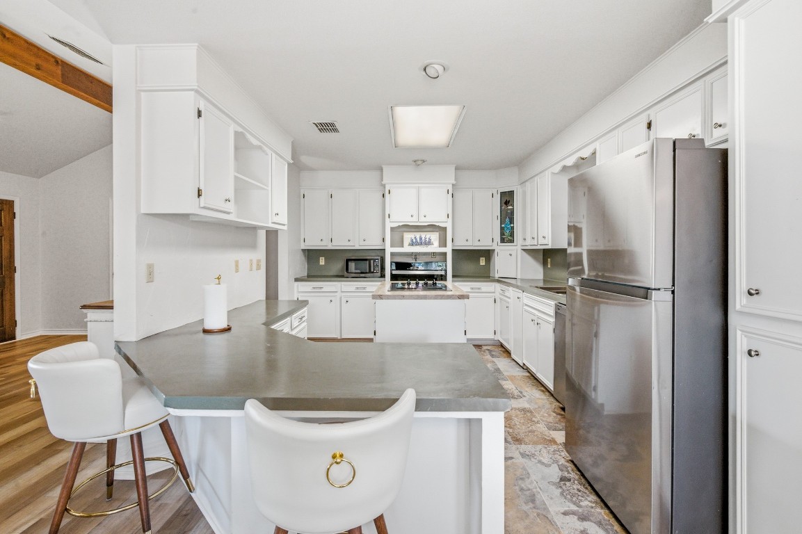 11847 Friar Road Cuero, TX 77954 - Photo 23 of 50 a kitchen with stainless steel appliances granite countertop a sink a refrigerator and a stove top oven