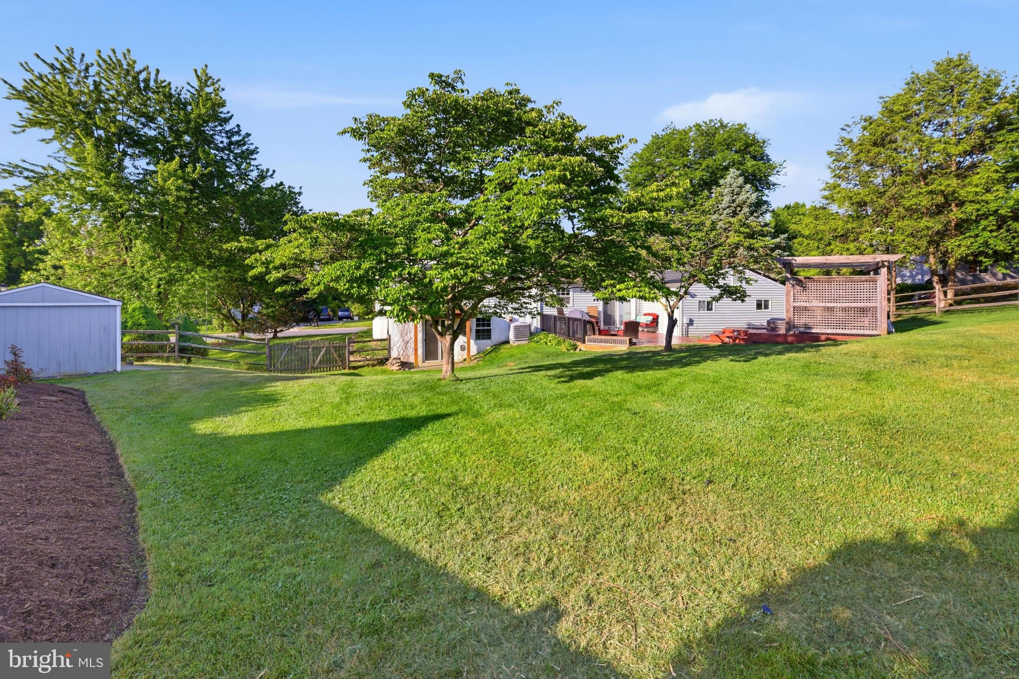 10405 Carlyn Ridge Road Damascus, MD 20872 - Photo 37 of 56 a view of a house with a big yard potted plants and large tree
