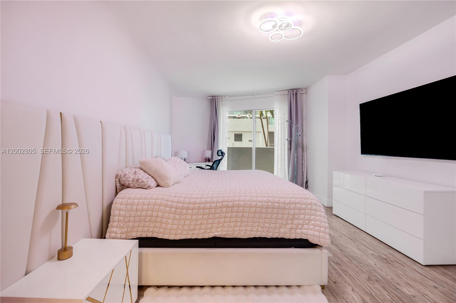 60 Southwest 13th Street, Unit 1124 Miami, FL 33130 - Photo 11 of 30 a bedroom with a large bed and a flat screen tv