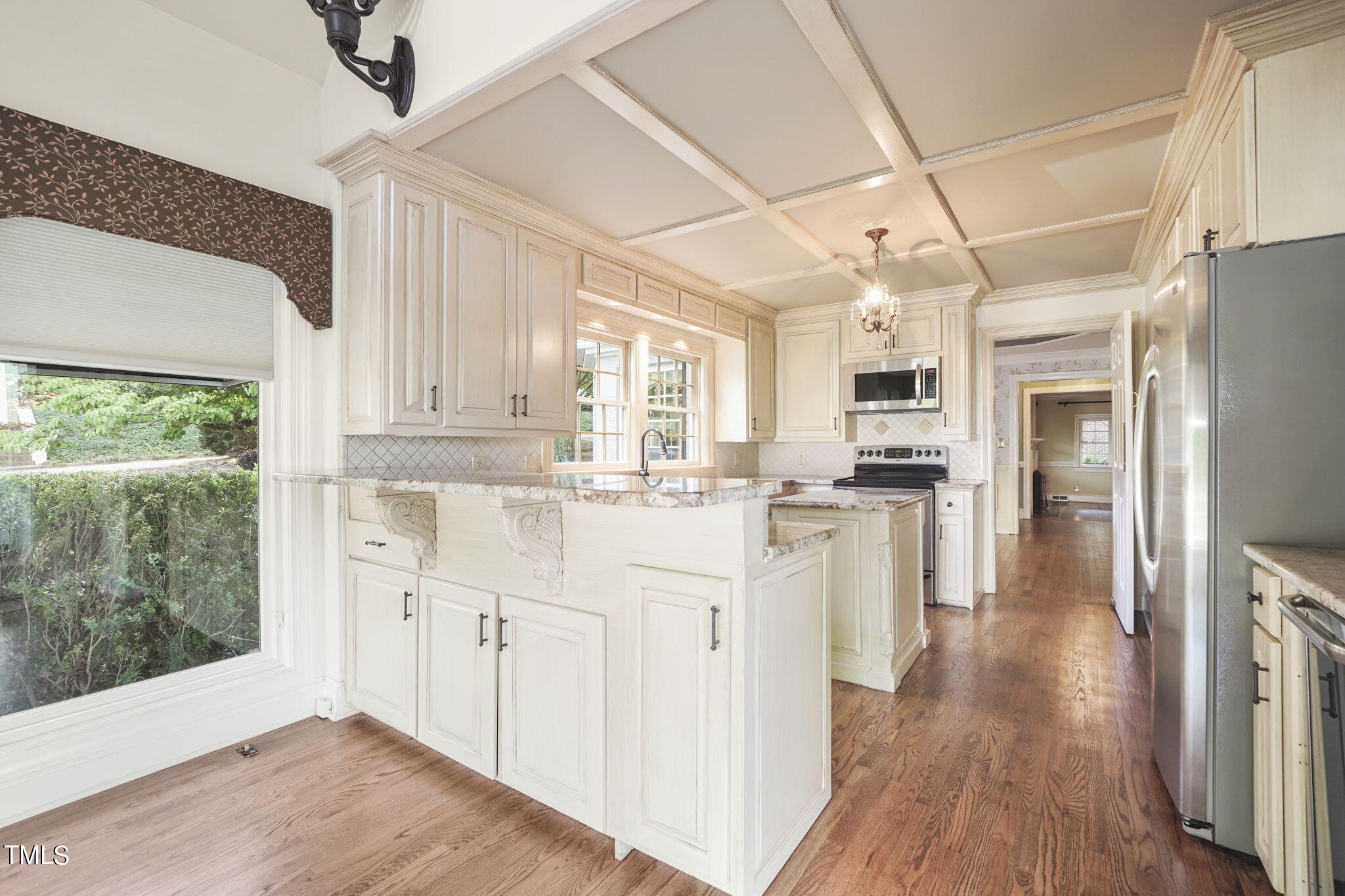 3100 Eton Road Raleigh, NC 27608 - Photo 14 of 45 a kitchen with white cabinets and wooden floor