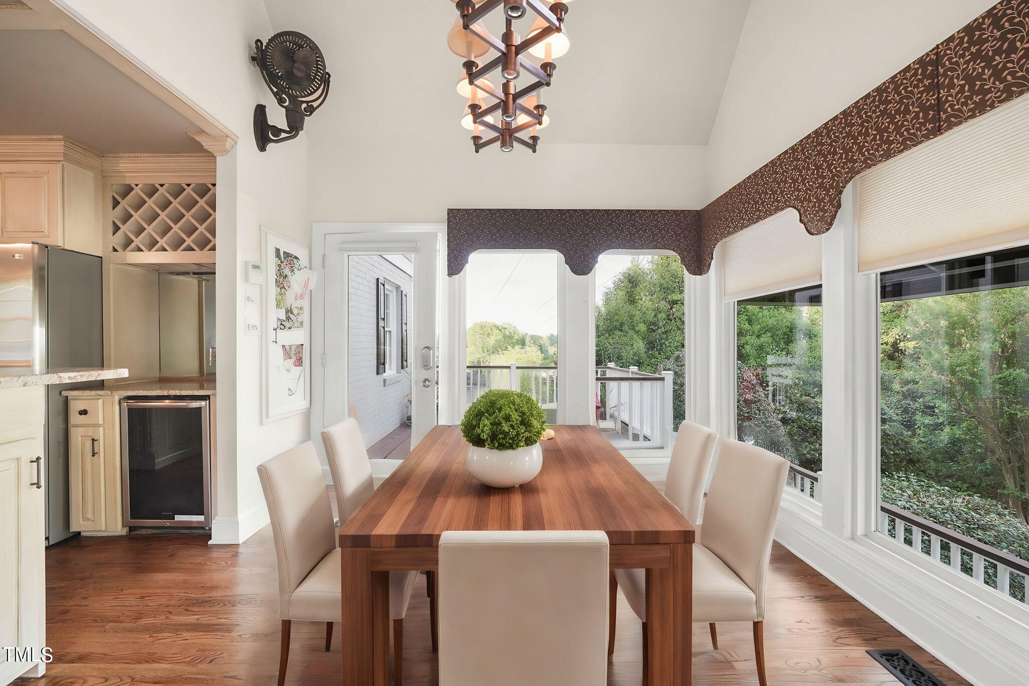 3100 Eton Road Raleigh, NC 27608 - Photo 15 of 45 a view of a dining room with furniture large windows wooden floor and chandelier