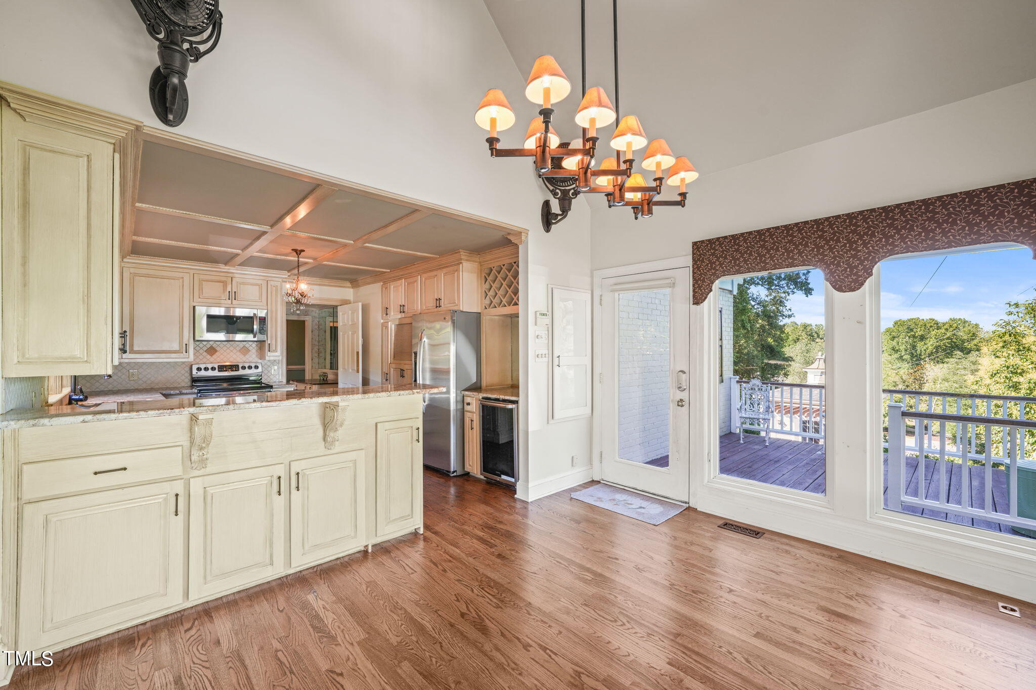 3100 Eton Road Raleigh, NC 27608 - Photo 16 of 45 a view of a kitchen with a sink wooden floor and chandelier