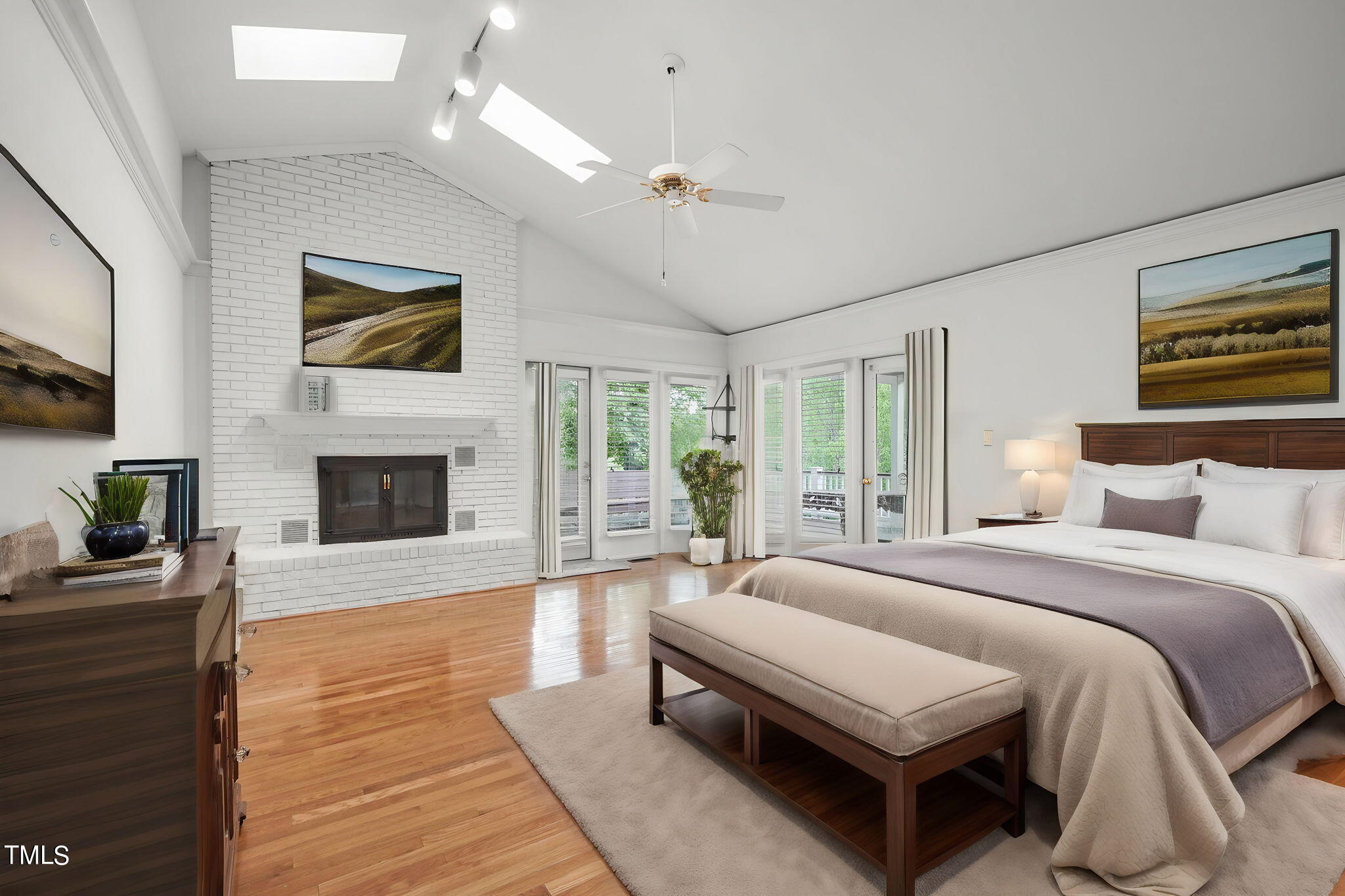 3100 Eton Road Raleigh, NC 27608 - Photo 18 of 45 a spacious bedroom with a balcony a bed and a fireplace