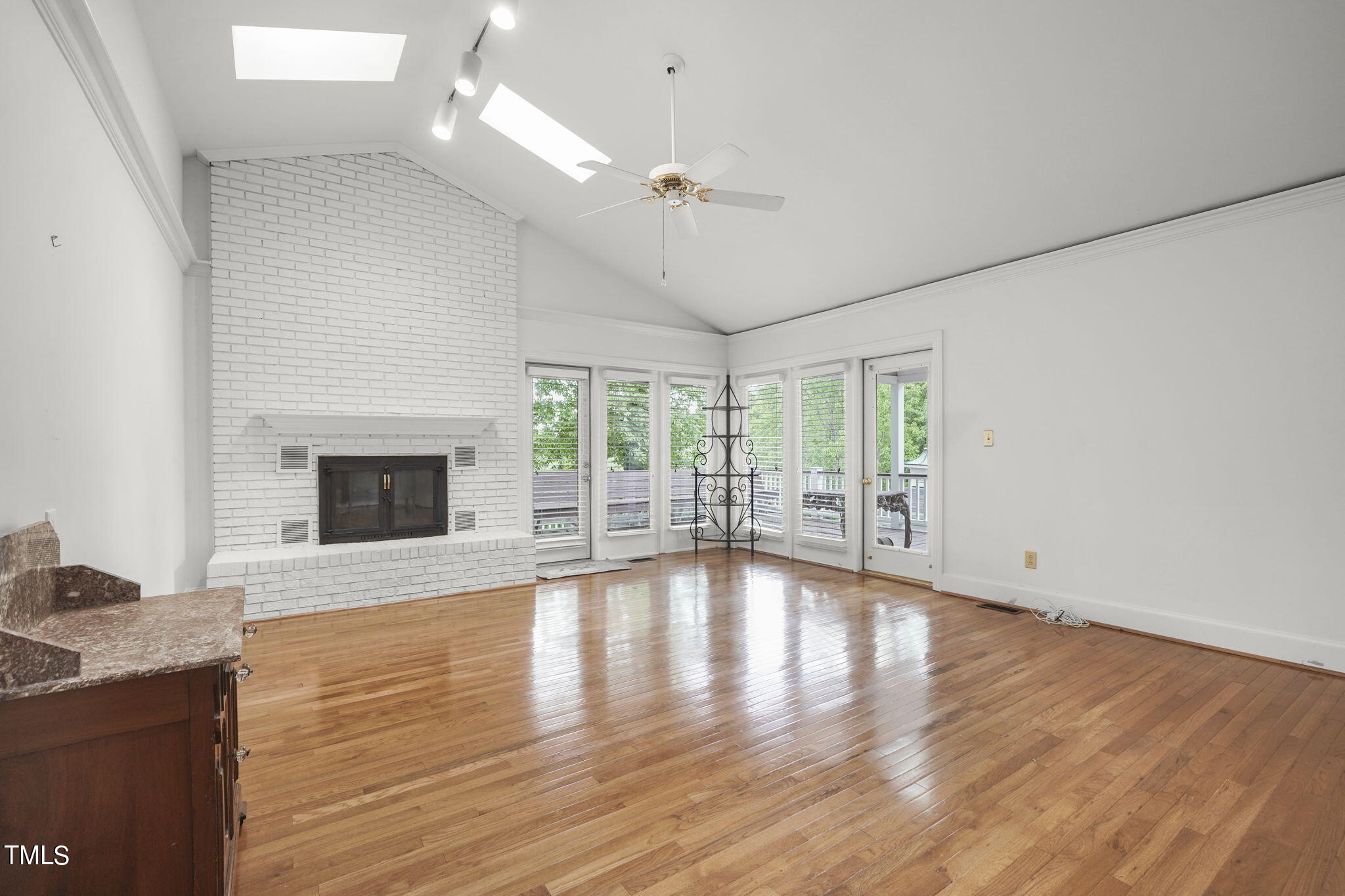 3100 Eton Road Raleigh, NC 27608 - Photo 21 of 45 a view of an empty room with wooden floor and a fireplace