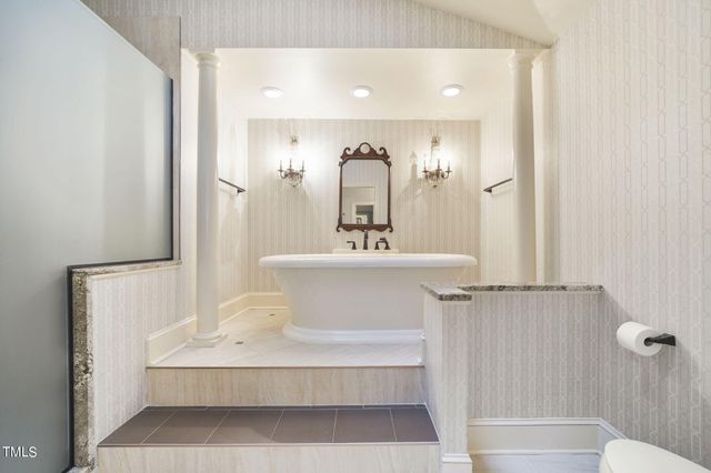 a spacious bathroom with a granite countertop sink mirror and a